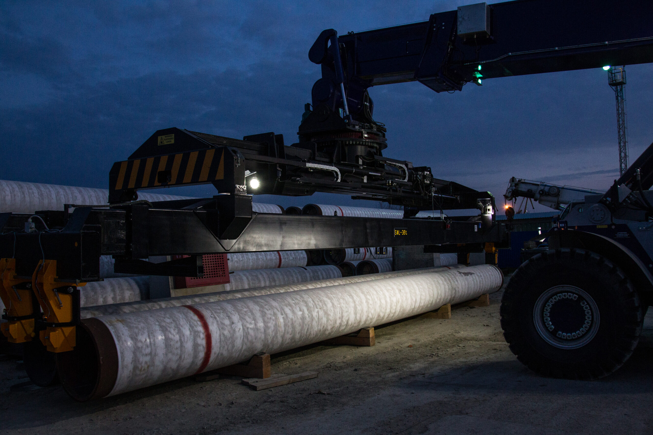 Customized Efficiency: Delivery of Reach Stackers with Tailored Attachments for Pipe Handling